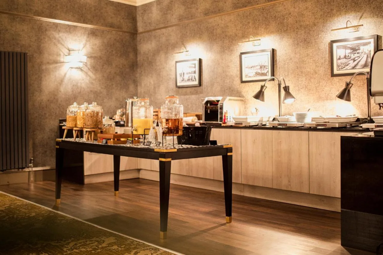 a table in a room with a counter with drinks on it at The Station Hotel in Aberdeen