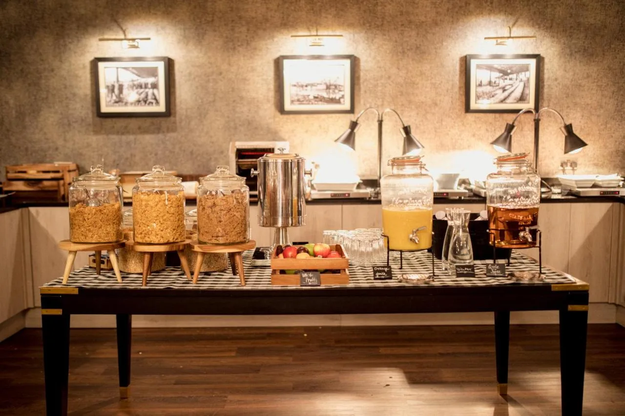 a table with jars of food and drinks on it at The Station Hotel in Aberdeen