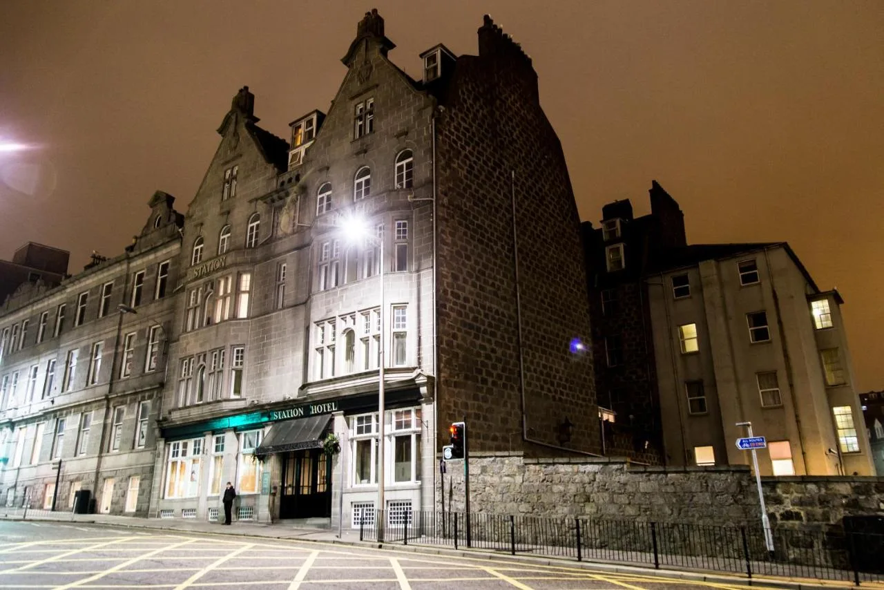 a large building with a street light in front of it at The Station Hotel in Aberdeen